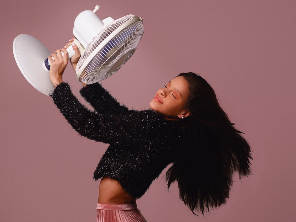 woman cooling with a fan